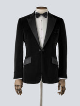 Load image into Gallery viewer, A black velvet dinner jacket designed for black-tie events, featuring a single-breasted one-button closure with a link button, silk peak lapels, and elegant paisley lining. Details include silk-covered buttons, double vents, a handkerchief pocket, and slanted silk pocket flaps that can be tucked in for a jetted look.