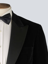 Load image into Gallery viewer, A black velvet dinner jacket designed for black-tie events, featuring a single-breasted one-button closure with a link button, silk peak lapels, and elegant paisley lining. Details include silk-covered buttons, double vents, a handkerchief pocket, and slanted silk pocket flaps that can be tucked in for a jetted look.