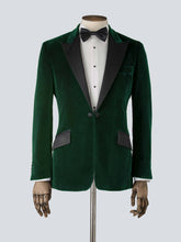 Load image into Gallery viewer, A green velvet dinner jacket designed for black-tie events, featuring a single-breasted one-button closure with a link button, silk peak lapels, and elegant paisley lining. Details include silk-covered buttons, double vents, a handkerchief pocket, and slanted silk pocket flaps that can be tucked in for a jetted look.