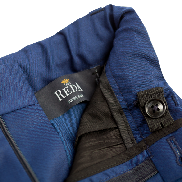 Close-up of a blue trousers for children with an elasticated waistband on a white background