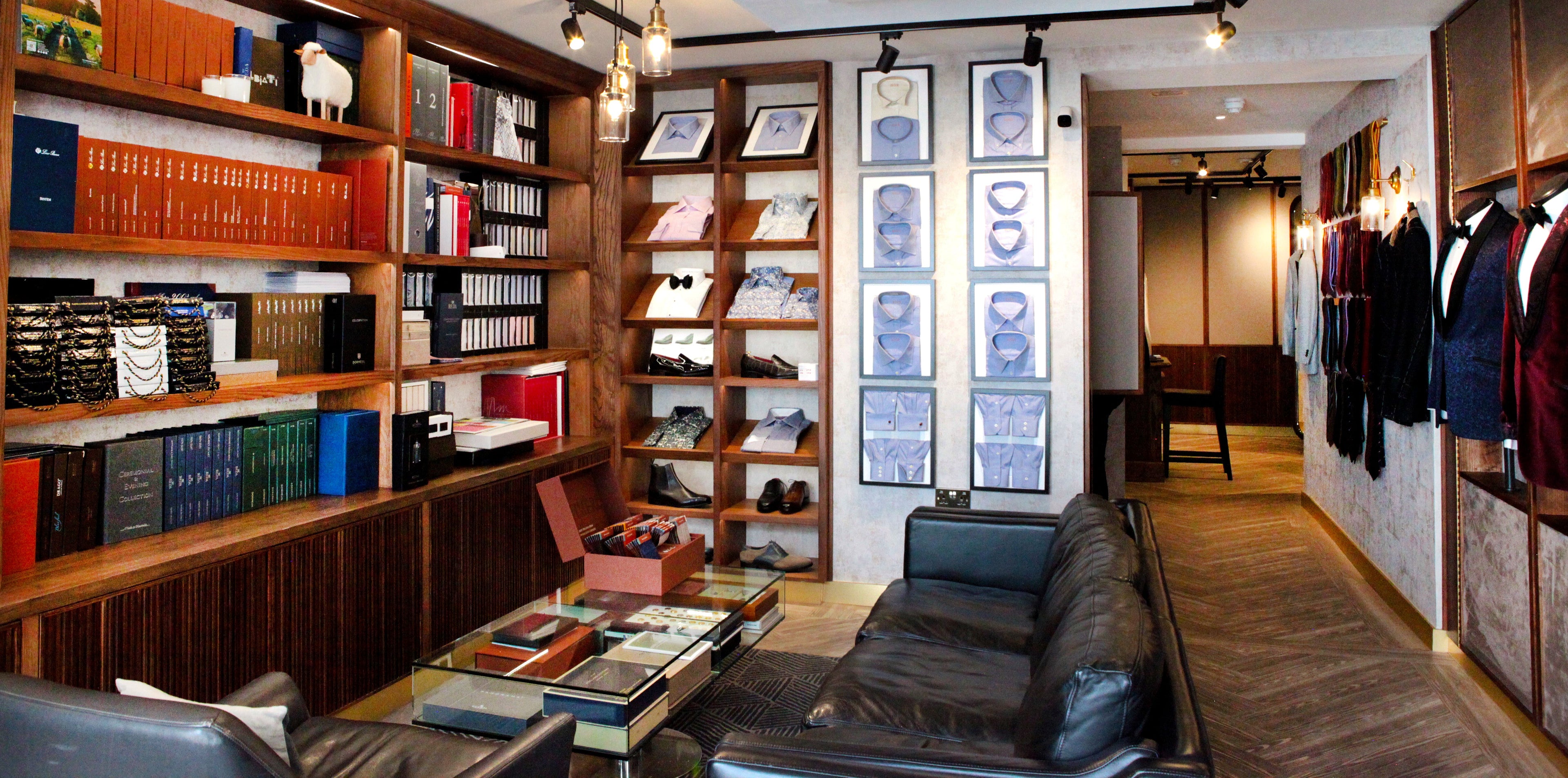 Interior of a Savile Row Custom Made store with bookshelves, shirt display and a sofa.