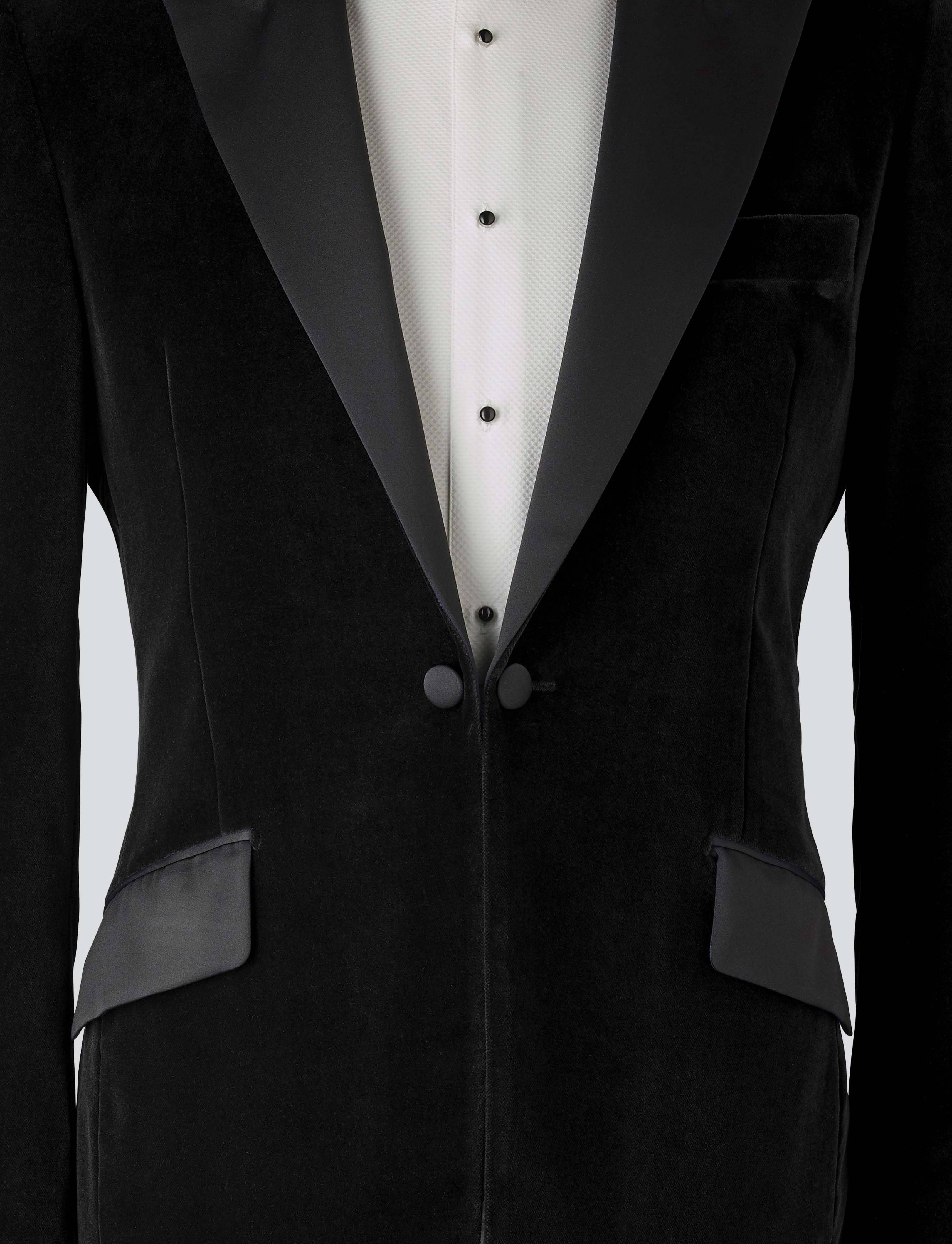 A black velvet dinner jacket designed for black-tie events, featuring a single-breasted one-button closure with a link button, silk peak lapels, and elegant paisley lining. Details include silk-covered buttons, double vents, a handkerchief pocket, and slanted silk pocket flaps that can be tucked in for a jetted look.